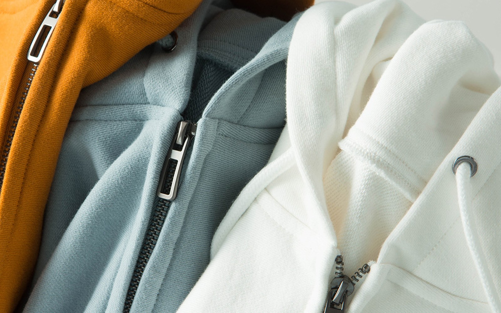 Metal zippers with custom pullers on hoodies